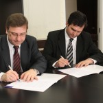 El Dr. Juan Carlos Mena y el Dr. Pablo Raúl Storni suscribiendo el Convenio.